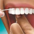 close up of using floss on teeth